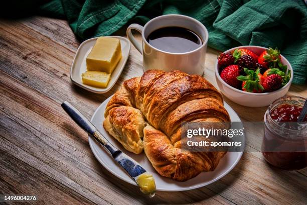 breakfast with cup of coffee, croissants, marmalade, and fruits on wooden table - croissant jam stock pictures, royalty-free photos & images