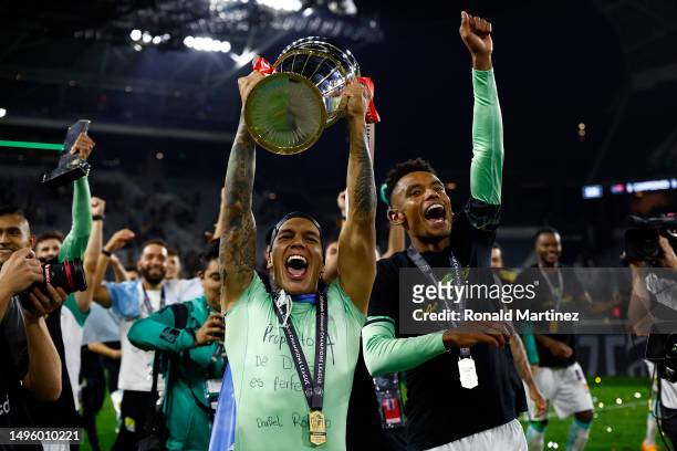 Lucas Romero and William Tesillo of Leon celebrate with the championship trophy after a 1-0 win against Los Angeles FC in the Concacaf Champions...
