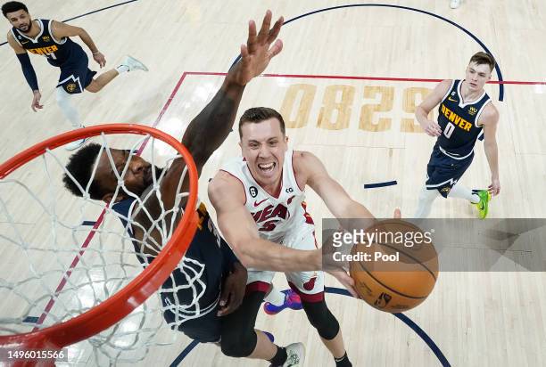 Duncan Robinson of the Miami Heat drives to the basket against Jeff Green of the Denver Nuggets in Game Two of the 2023 NBA Finals at Ball Arena on...