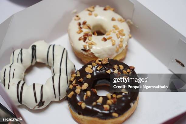 donut in paper box - close up bread roll black backdrop horizontal stock pictures, royalty-free photos & images