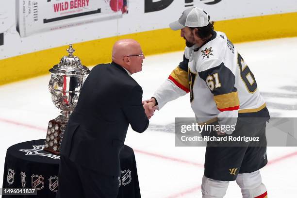 Deputy NHL Commissioner Bill Daly shakes hands with Mark Stone of the Vegas Golden Knights at the presentation of the Clarence S. Campbell Bowl after...