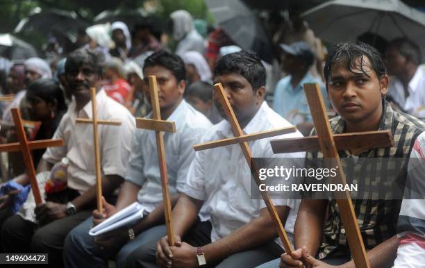 Indian Dalit - untouchable - Christians and Muslims sit in the rain during a protest rally against the National Commission for Scheduled Castes and...