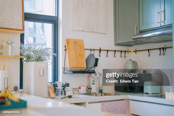 cozy kitchen island counter in small apartment - microwave dish stock pictures, royalty-free photos & images