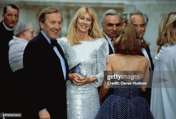 British television presenter and journalist Sir David Frost and wife Lady Carina Fitzalan-Howard attend the 50th birthday party for Constantine II of...