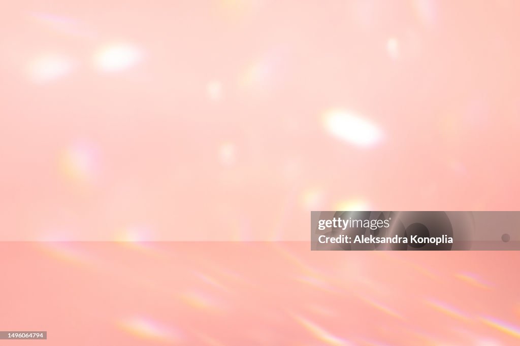 Empty soft pink colored scene - abstract studio room, stage background with crystal rainbow light refraction, disco ball light effects, front view, copy space
