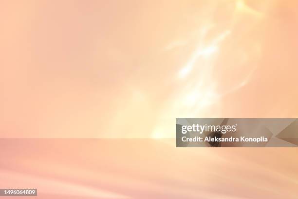 light beige, soft pink, nude color display background with dreamy golden sunny light. empty 3d stage template with caustic light effects. trendy warm natural colors - fond beige photos et images de collection
