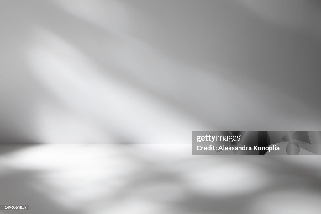 Empty studio room background with abstract diagonal window light and shadows. Minimal 3d monochrome architectural stage with dreamy soft light. Front view, copy space