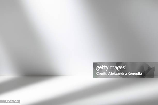 empty studio interior with sunny window lighting. blank stage with soft shadows and light mockup. front view, copy space. - plain packaging stock pictures, royalty-free photos & images