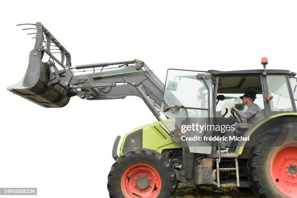 a farmer carefully drives his tractor - michel field stockfoto's en -beelden