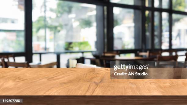 wooden board empty table in front of blurred background.  brown wood over blur in coffee shop. can be used for display or montage your products. mock up for display of product. - 食堂　無人 ストックフォトと画像