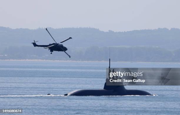Germany Navy Sea Lynx helicopter flies over submarine U33 in the Baltic Sea on June 05, 2023 near Rostock, Germany. NATO military ships will be...