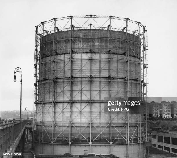 Gas holder , a large container for the storage of natural gas, location unspecified, circa 1950.