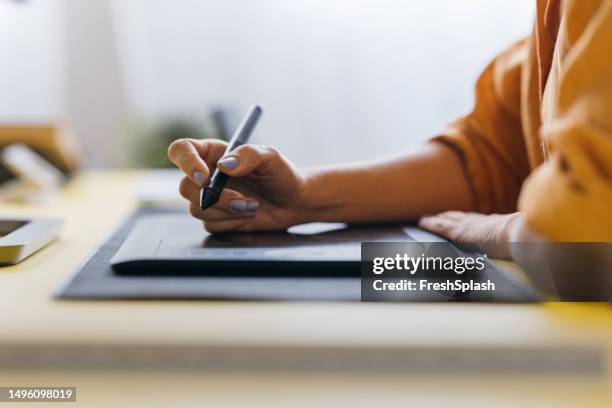a close up view of an unrecognizable businesswoman working in the office using her drawing board - graphic designer stock pictures, royalty-free photos & images