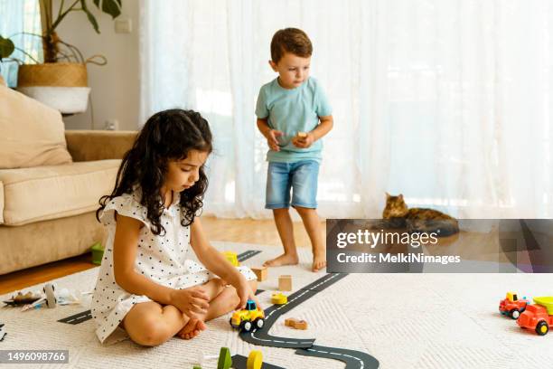 children crawling on the carpet and playing traffic with toys, learning about traffic rules - boy playing with cars stock pictures, royalty-free photos & images