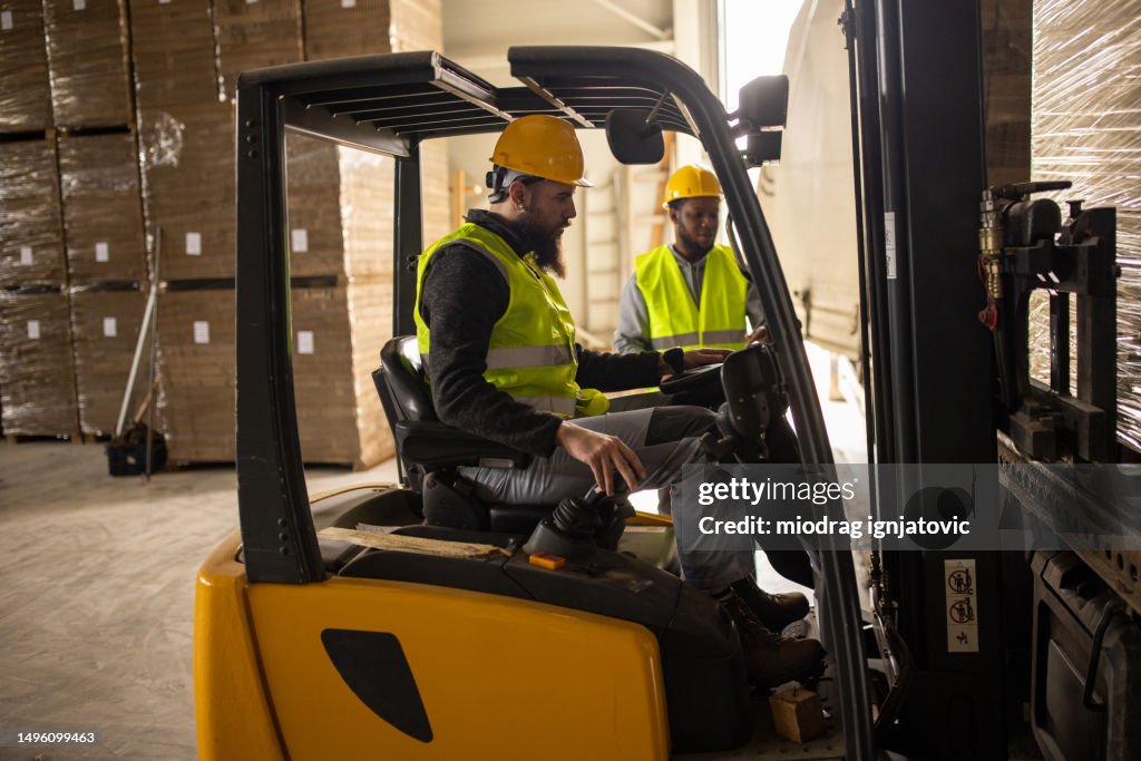 Loading Truck With 4 People Young Man Loading A Truck Trailer Using A Forklift High-Res Stock Photo ...