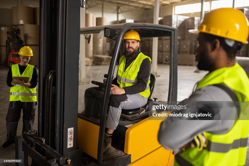 Loading Truck With 4 People Young Man Loading A Truck Trailer Using A Forklift High-Res Stock Photo ...