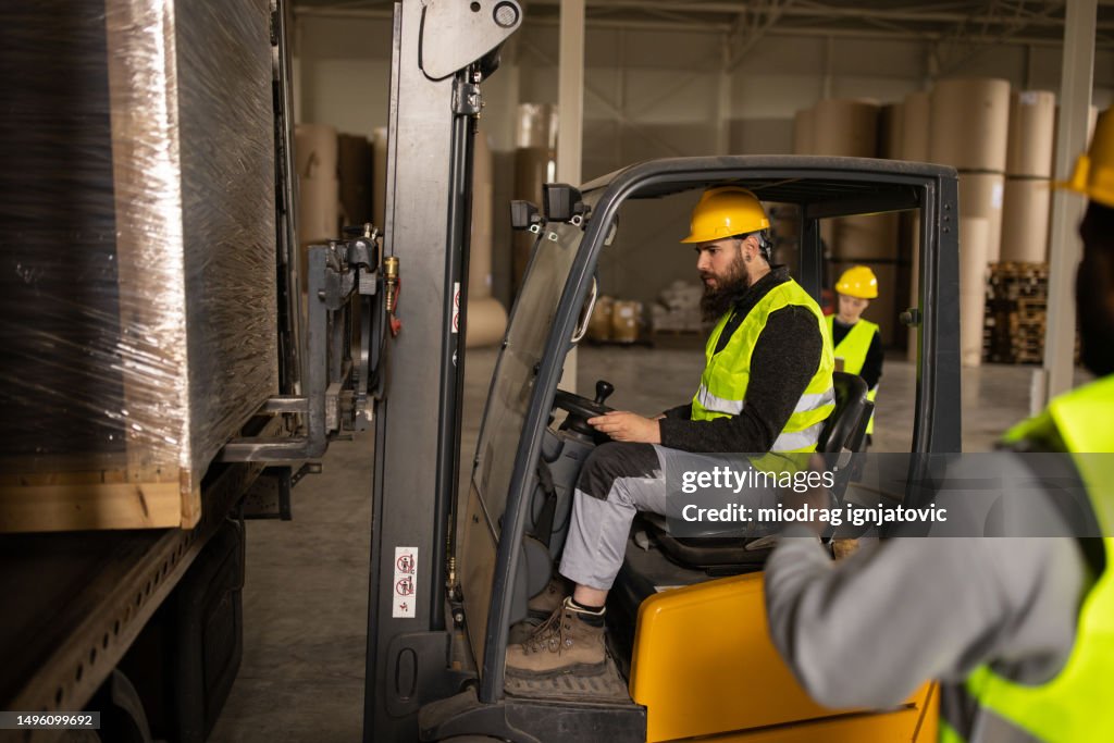 Loading Truck With 4 People Young Man Loading A Truck Trailer Using A Forklift High-Res Stock Photo ...