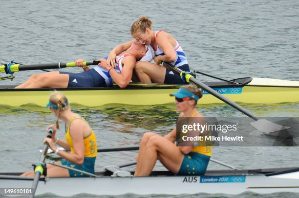 Heather Stanning and Helen Glover celebrate after winning gold next to bottom Sarah Tait and Kate Hornsey of Australia in the Women's Pair Final on...