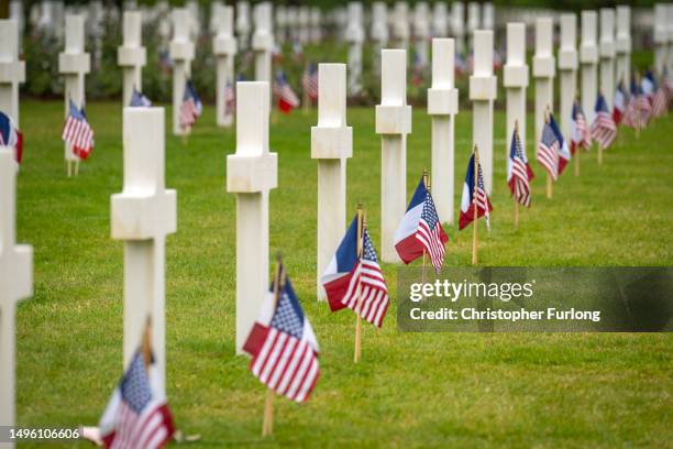 United States and French flags stand next to the graves of the fallen at the Normandy American Cemetery ahead of tomorrow's D-Day commemorations on...