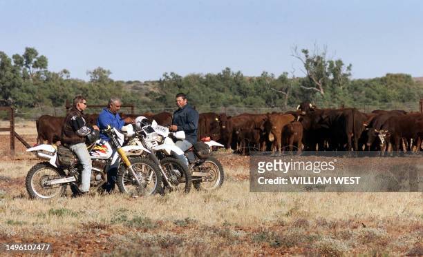 Workers from the Anna Creek cattle station take a break on the Oodnadatta Track in outback South Australia as they start the mustering of cattle by...