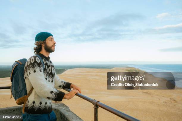 man standing on the top of rubjerg knude lighthouse - north sea denmark stock pictures, royalty-free photos & images