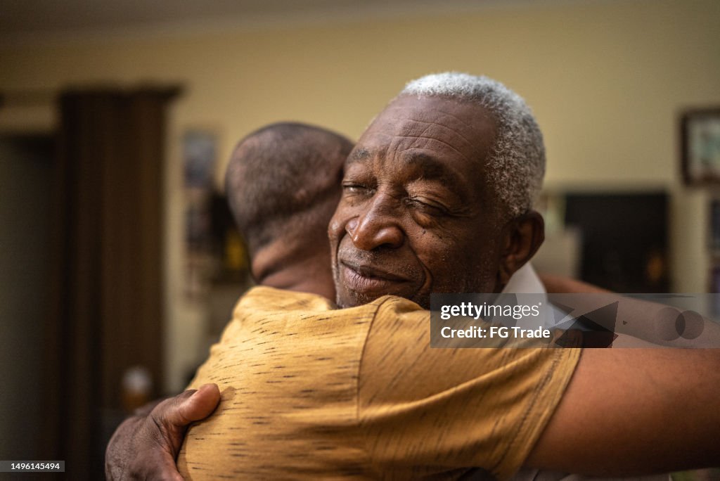 Bonding moment of father and son embracing and giving emotional support at home