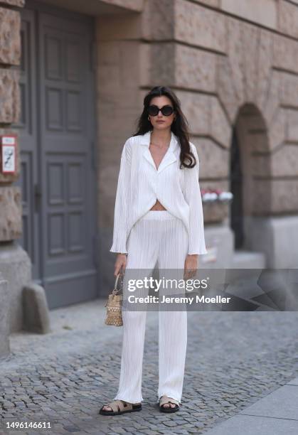 Celine Bethmann wears Hermes Chypre brown velvet leather sandals, Celine black shades, ninety9 matching white linen flannel and wide pants and Jimmy...