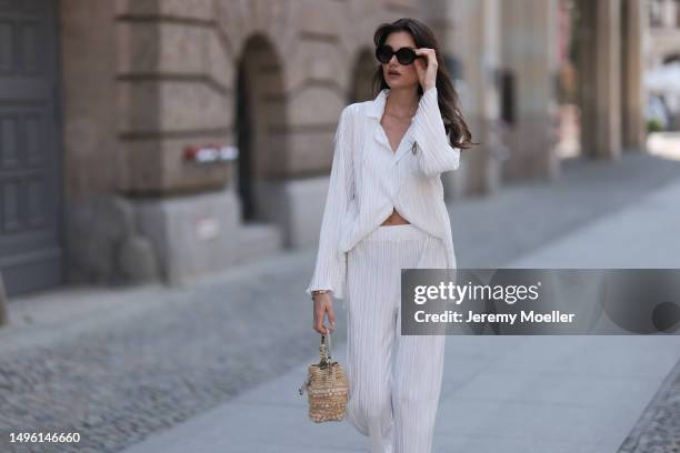 Celine Bethmann wears Hermes Chypre brown velvet leather sandals, Celine black shades, ninety9 matching white linen flannel and wide pants and Jimmy...