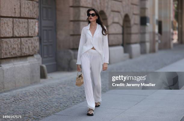 Celine Bethmann wears Hermes Chypre brown velvet leather sandals, Celine black shades, ninety9 matching white linen flannel and wide pants and Jimmy...