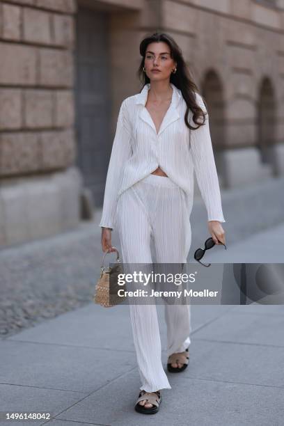 Celine Bethmann wears Hermes Chypre brown velvet leather sandals, Celine black shades, ninety9 matching white linen flannel and wide pants and Jimmy...