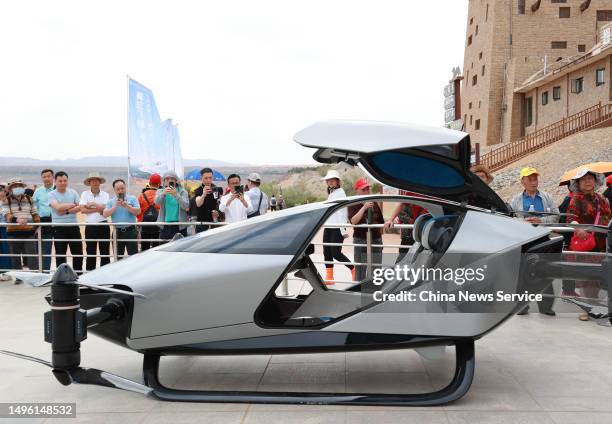 Tourists watch a XPeng Voyager X2 Flying Car at Shapotou scenic spot on June 5, 2023 in Zhongwei, Ningxia Hui Autonomous Region of China.