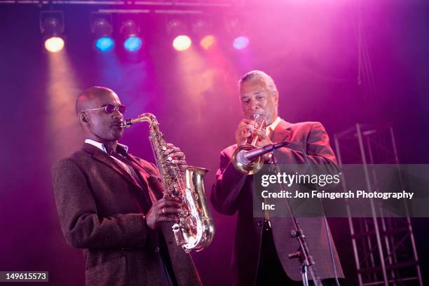 musicians playing in jazz band on stage - blues stock-fotos und bilder