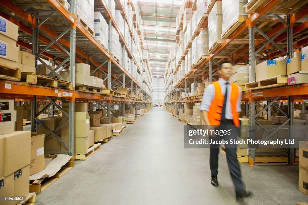 Manager walking in warehouse