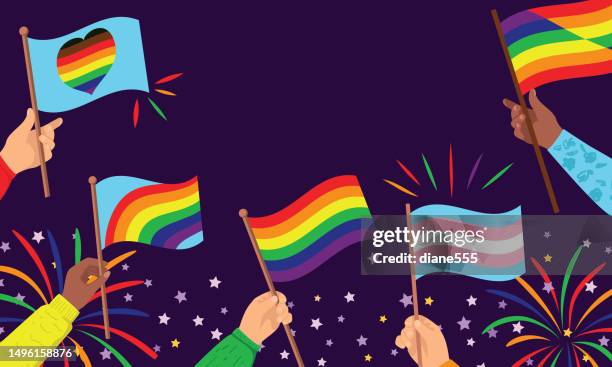 hands holding pride flags - pride flag stock illustrations