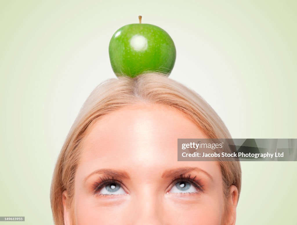 Caucasian woman with an apple on her head
