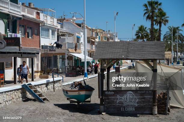 Restaurant staff cook sardines and fish on open fires on the Pedregalejo Playa beach on April 20, 2023 in Malaga, Spain.