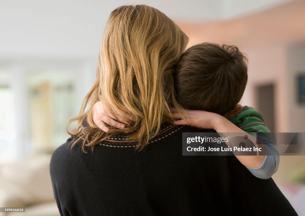 Caucasian mother comforting son