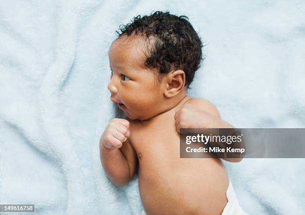 mixed race newborn baby laying on blanket - supino foto e immagini stock