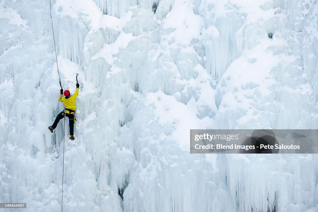 Caucasian man climbing ice