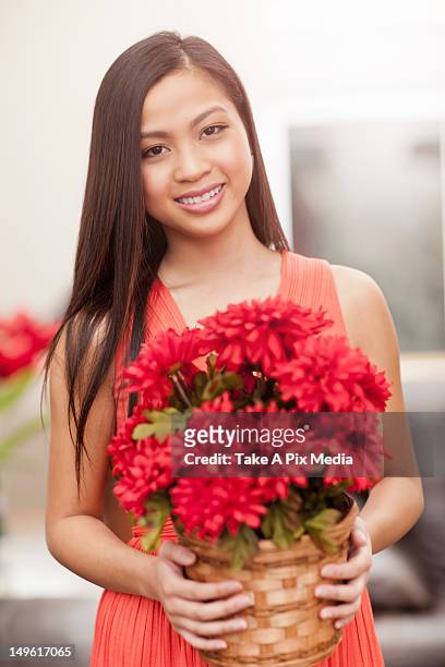 pacific islander woman holding flowers -  "suprijono suharjoto" or "take a pix media" stock pictures, royalty-free photos & images