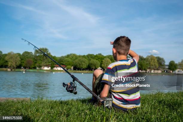 the boy is fishing - kids fishing stock pictures, royalty-free photos & images