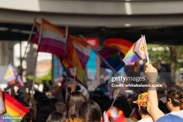 asian group of people celebrating the pride month on a pride event. - pride flag stock pictures, royalty-free photos & images