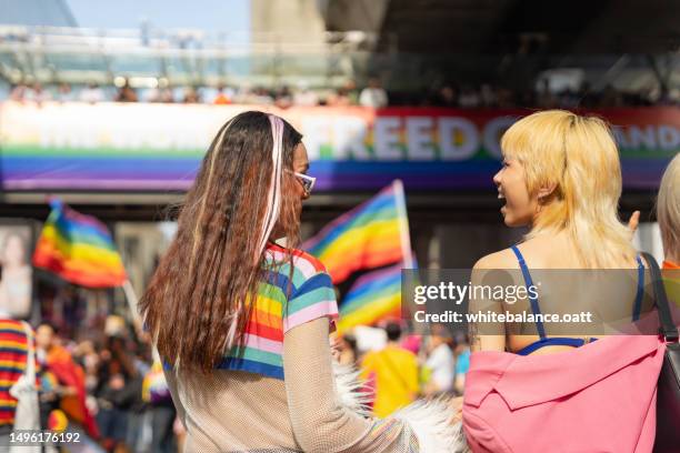 happy asian friend having fun in the street lgbtq pride parade. - block party stock pictures, royalty-free photos & images