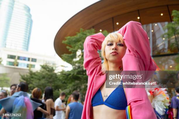 happy asian friend having fun in the street lgbtq pride parade. - lgbt history stock pictures, royalty-free photos & images