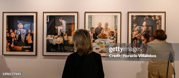 Special guests watch the works of art being exhibited at the exhibition "Democracy Collection: Advocacy Through Art" before its inauguration by U.S....