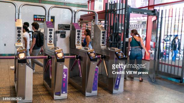 People go through the exit door without paying the MTA fare at a subway station in middle Manhattan on June 5, 2023 in New York City.