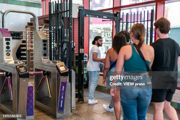 People go through the exit door without paying the MTA fare at a subway station in middle Manhattan on June 5, 2023 in New York City.