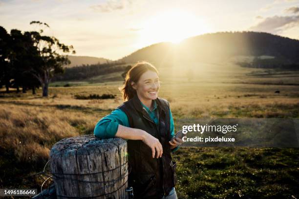 staying connected on the farm via mobile network - farmer female confident stock pictures, royalty-free photos & images