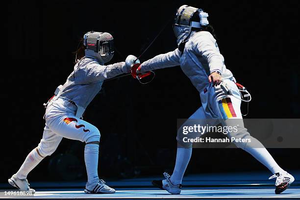 Min Zhu of China competes against Bianca Pascu of Romania in the Women's Sabre Individual round 32 match on Day 5 of the London 2012 Olympic Games at...