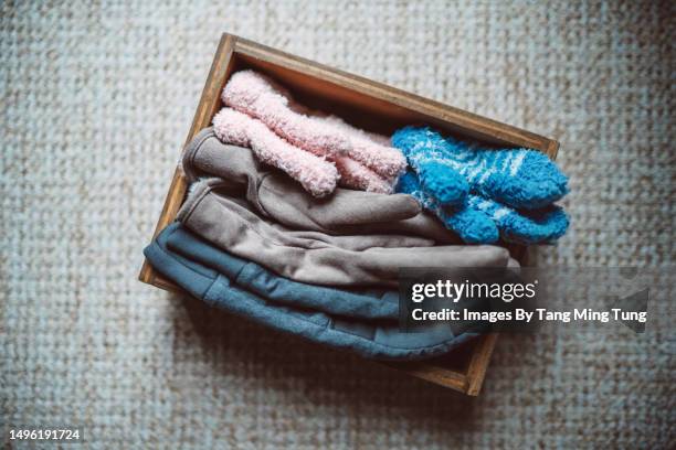 directly above view of a wooden box holding mittens of a family with two kids - the package tour stock pictures, royalty-free photos & images